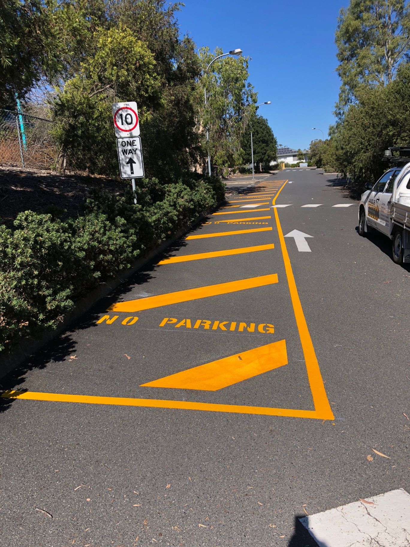 Yellow no-parking line marking and hatching along residential driveway