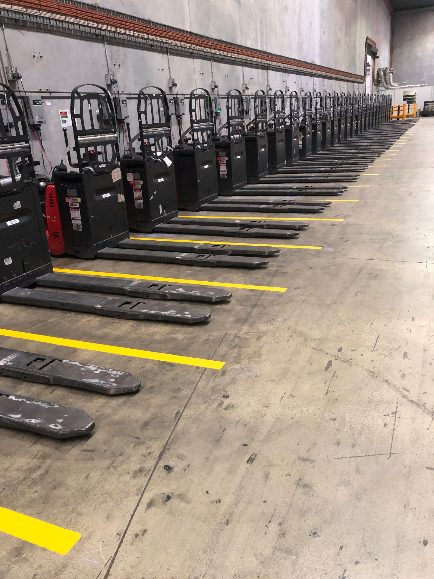 Yellow pallet jack bay line marking inside warehouse