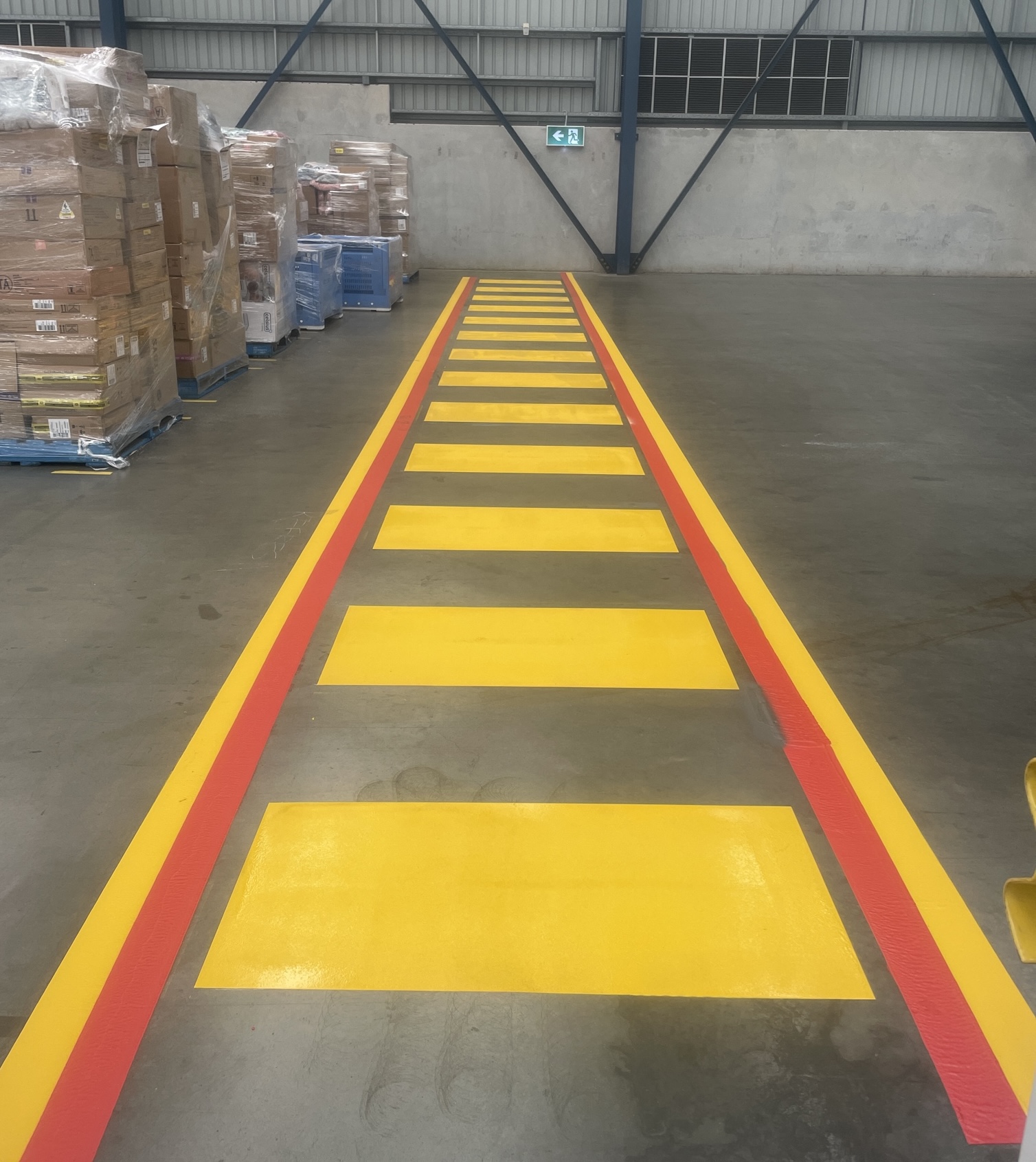 Yellow and red warehouse pedestrian crossing markings