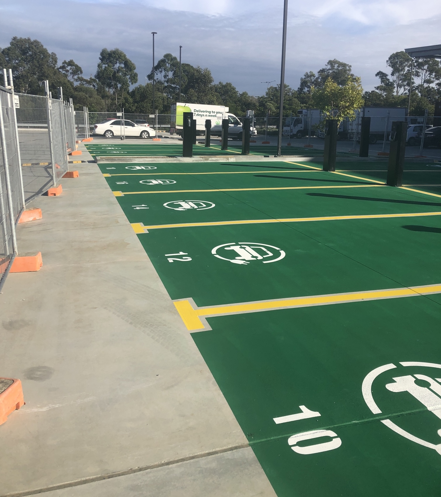 Green EV charging bays with line marking and stencils
