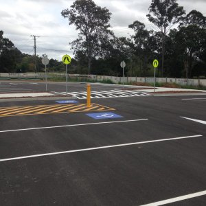 Parking bay line markings and priority signage